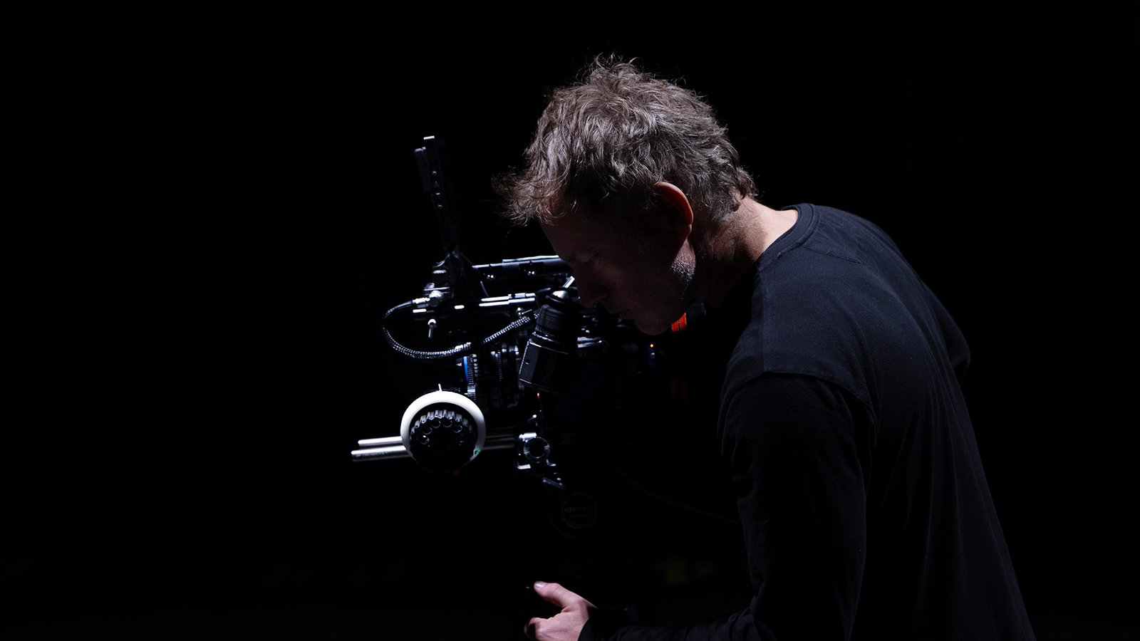 Joshua Michael Shelton directing on a film set with a cinema camera